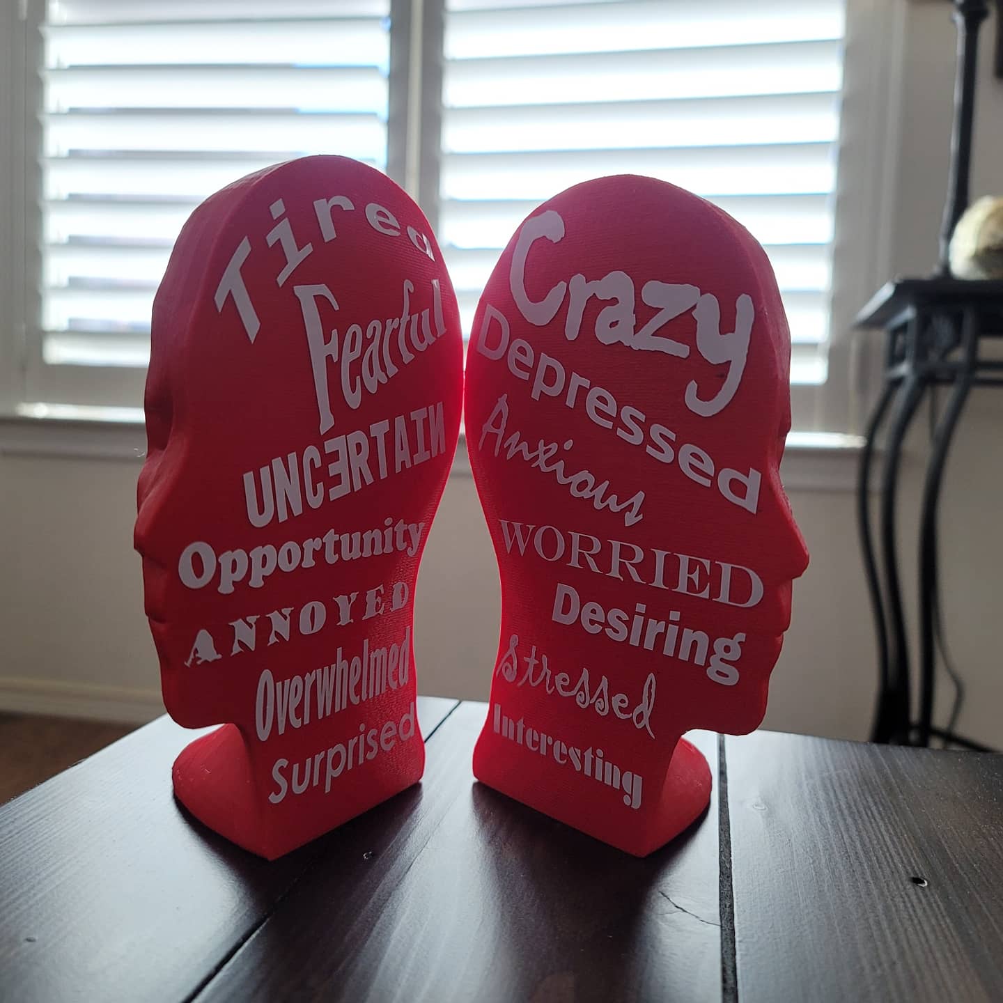 Two 3D printed heads turned outwards to show inside design.